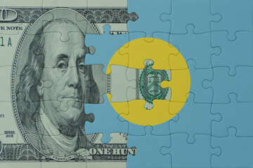 puzzle with the national flag of Palau and dollar money banknote. macro.concept.