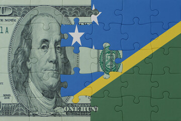 puzzle with the national flag of Solomon Islands and dollar money banknote. macro.concept.