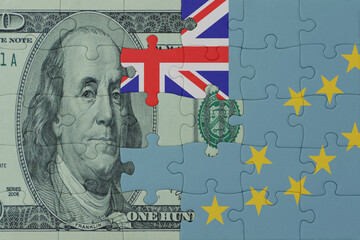 puzzle with the national flag of Tuvalu and dollar money banknote. macro.concept.