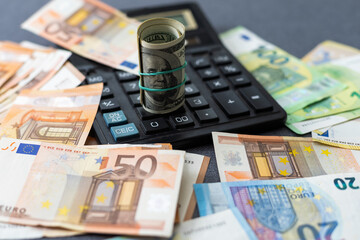 Euro and dollar notes. euro against dollar. A closer look of the president of the USA with a dollar bill, peeping out from behind a euro bill. USA and Europe finance relation. Close up top view.