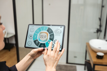 Woman at home using smart screen, automation domestic system