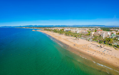 Beach, blue sea and palm trees in Salou city, Catalonia, Spain, Europe