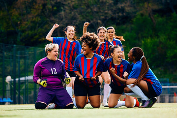 Obraz premium Happy female players celebrate victory after soccer match at stadium.