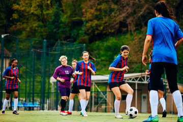 Obraz premium Female soccer players having sports training at stadium.