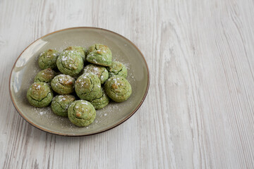 Homemade Soft Amaretti Cookies with Pistachio on a Plate, side view.