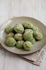 Homemade Soft Amaretti Cookies with Pistachio on a Plate, side view.
