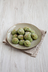Homemade Soft Amaretti Cookies with Pistachio on a Plate, side view.