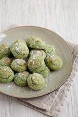 Homemade Soft Amaretti Cookies with Pistachio on a Plate, side view.