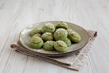 Homemade Soft Amaretti Cookies with Pistachio on a Plate, side view.