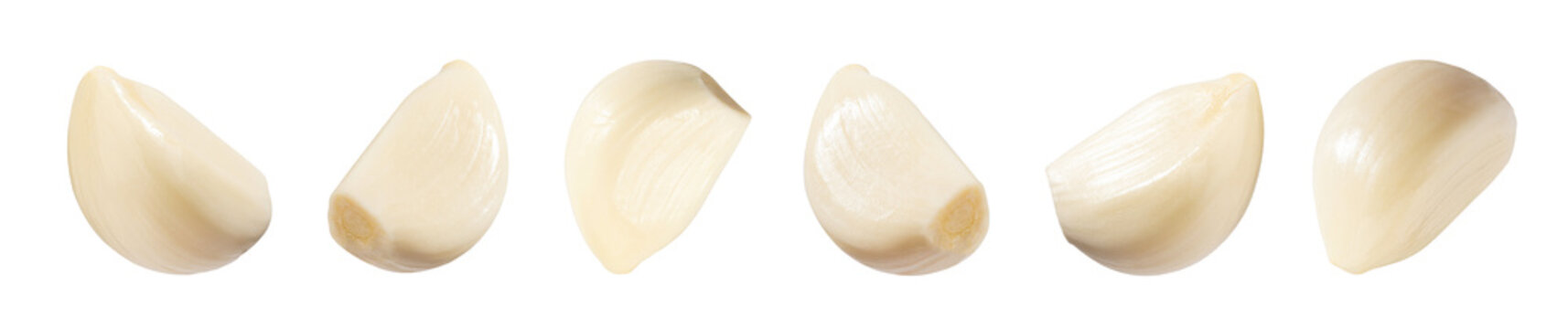 Falling peeled garlic cloves isolated on white background with clipping path. Food and spices objects for design. Spicy and fragrant seasoning concept