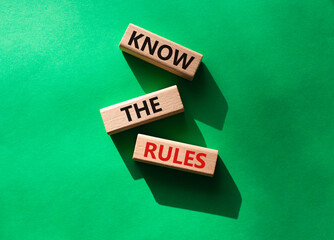 Know the rules symbol. Wooden blocks with words Know the rules. Beautiful green background....