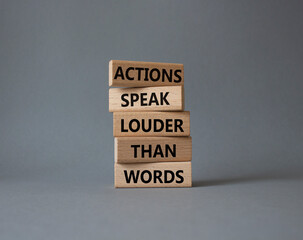 Actions speak louder than Words symbol. Wooden blocks with words Actions speak louder than Words....