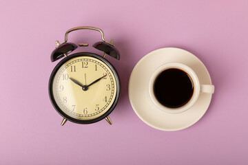 Good morning coffee and alarm clock concept on bright colored background.Top view.Good morning...