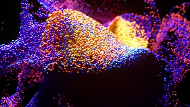 Whirlwind of colored particles on a black isolated background. Video animation with surreal liquid color mixing splash