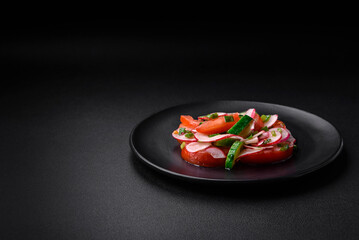 Delicious vegan salad of fresh vegetables of tomatoes, cucumbers and radishes