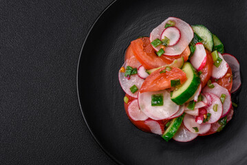 Delicious vegan salad of fresh vegetables of tomatoes, cucumbers and radishes