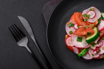 Delicious vegan salad of fresh vegetables of tomatoes, cucumbers and radishes