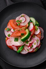 Delicious vegan salad of fresh vegetables of tomatoes, cucumbers and radishes