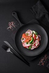 Delicious vegan salad of fresh vegetables of tomatoes, cucumbers and radishes