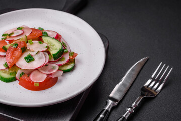 Delicious vegan salad of fresh vegetables of tomatoes, cucumbers and radishes