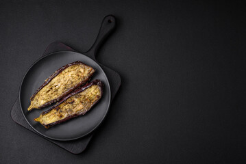 Delicious eggplant cut into two halves baked with salt, spices and herbs