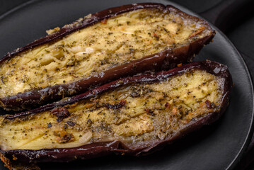 Delicious eggplant cut into two halves baked with salt, spices and herbs