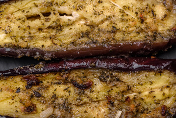 Delicious eggplant cut into two halves baked with salt, spices and herbs