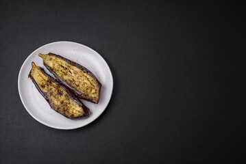 Delicious eggplant cut into two halves baked with salt, spices and herbs