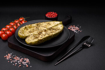 Delicious zucchini cut into two halves baked with salt, spices and herbs