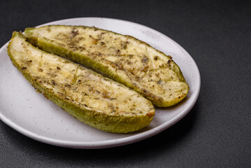 Delicious zucchini cut into two halves baked with salt, spices and herbs