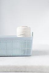 pastel blue organisation basket with a white background, Plastic blue basket for home organisation, pastel blue basket with a woven pattern