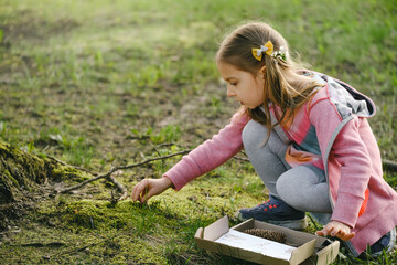 Scavenger hunt for kid in the park. Girl learning about environment. Natural education activity for...
