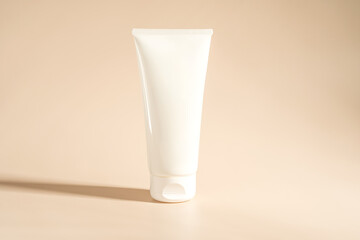 A white tube of face cream on a beige background, marketing presentation, mock up, branding