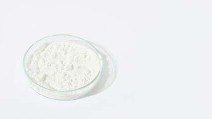 Fototapeta na wymiar White powder in a Petri dish. Cocaine, cannabinoid, medicinal powder, antibiotic. lab, research.