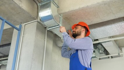 Ventilation system installation and repair service. Hvac technician at work