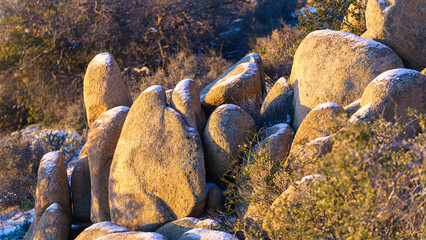 Grouping of rocks with snow on top during winter in Joshua Tree National Park, California