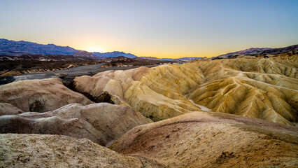 Sunrise over the borax rich badland hills at Zabriskie Point in Death Valley National Park in California, USA