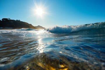 Naklejka premium Summer landscape, nature of tropical with rays of sun light. Beautiful sun glare in wave of transparent blue water on beach against blue sky. AI generative
