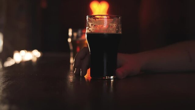 Two men drink beer in a bar