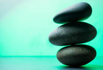 Obraz na płótnie Canvas zen stones for podium background .three zen stones in stack on light green background