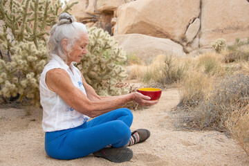 Senior Woman in the desert expressing wellness and heath. 