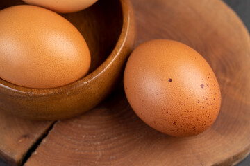A whole orange chicken egg close-up on the table