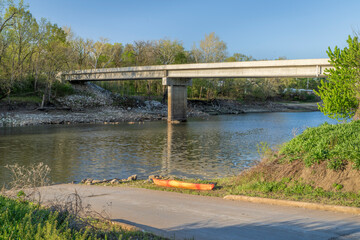 kayak on a boat ramp, Lamine River in early spring near Lamine, Missouri