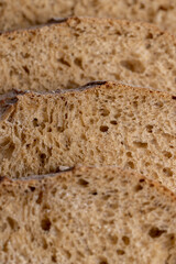 Cut into pieces fresh baked loaf of dark bread