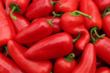 Red hot chili peppers as background, top view