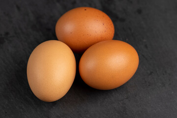 A whole orange chicken egg close-up on the table