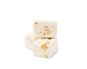 Pieces of delicious nougat on white background