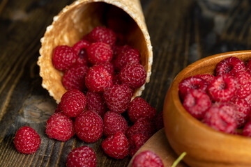 Harvested red ripe raspberries in a waffle cone