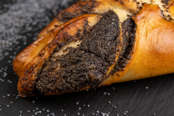 Fresh bun with poppy seed filling on the table