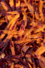 Sliced into thin slices of red-orange carrots in the kitchen
